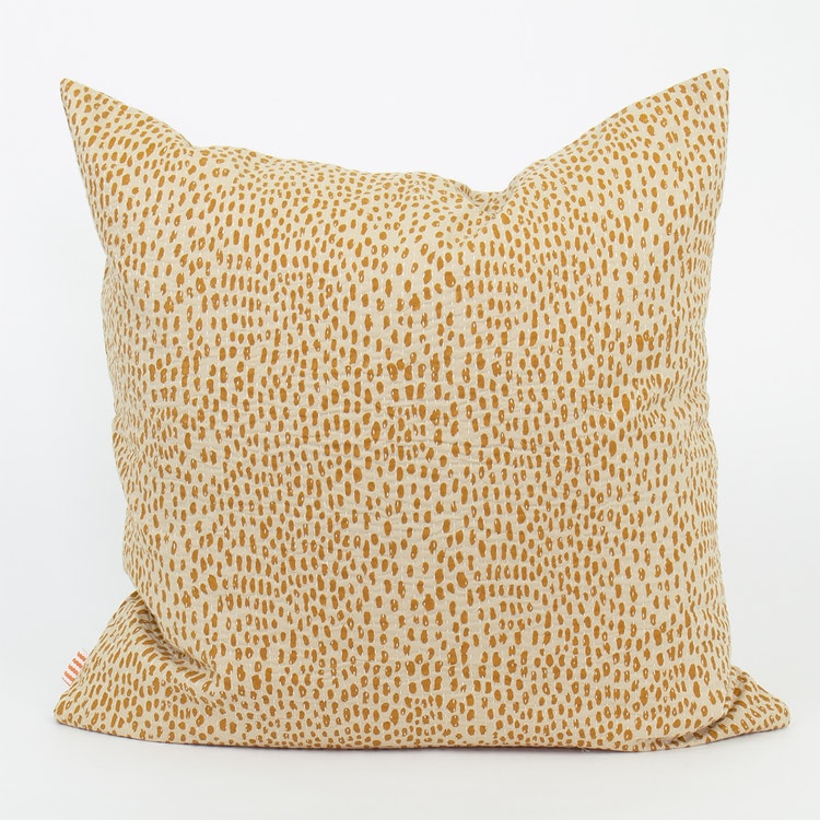 Afro art Storm cushion cover in soft cotton with ocra yellow dots on off-white.