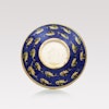A large, round handmade Iranian serving plate with hand painted colourful fish pattern on blue.