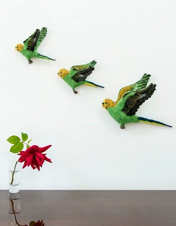 Flying green budgie trio