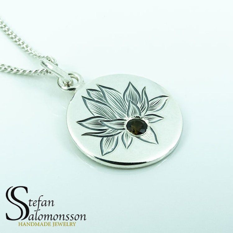 Hand-engraved lotus pendent in silver with a tourmaline