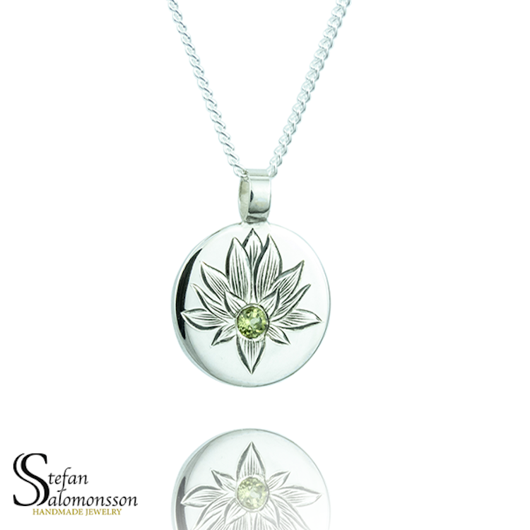 Hand-engraved lotus pendent in silver with a peridot