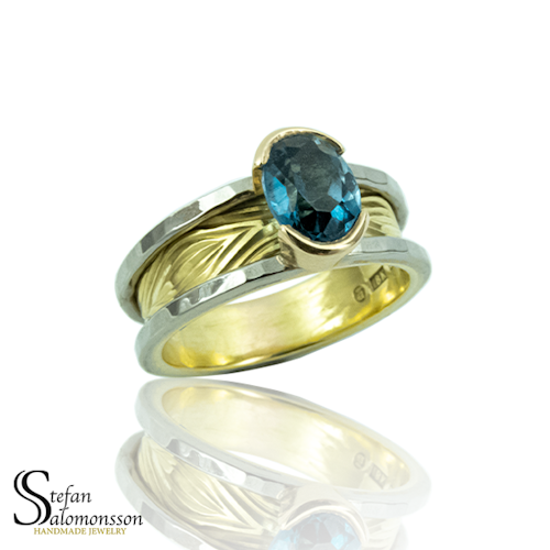 White- and red gold ring with a Royal Blue Topaz