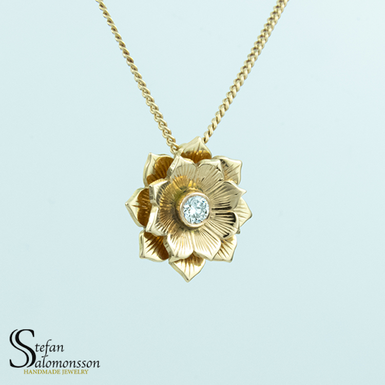 Gold lotus pendant with a diamond