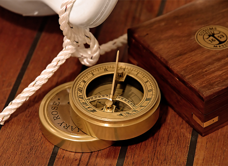 Compass and sundial in wooden box