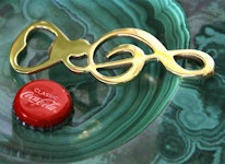 Bottle opener in the form of a note key