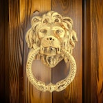 Door knocker in the shape of a lionhead, larger