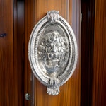 Door knocker with lion mascaron in nickel-plated brass