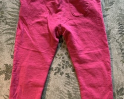 Ett par gråmelerade mjukisbyxor med rosa detaljer från Kaxs och ett par rosa byxor från Åhléns stl 86