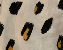 Gräddvit kortärmad och kortbent romper med leopardmönster i svart och gult från Lindex stl 62