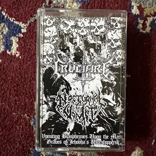 CRUCIFIRE / NOCTURNAL VOMIT Vomiting Blasphemies Upon The Mass Graves Of Jehovah's Worshippers (Grave Ritual - Spain reissue) (NM) TAPE