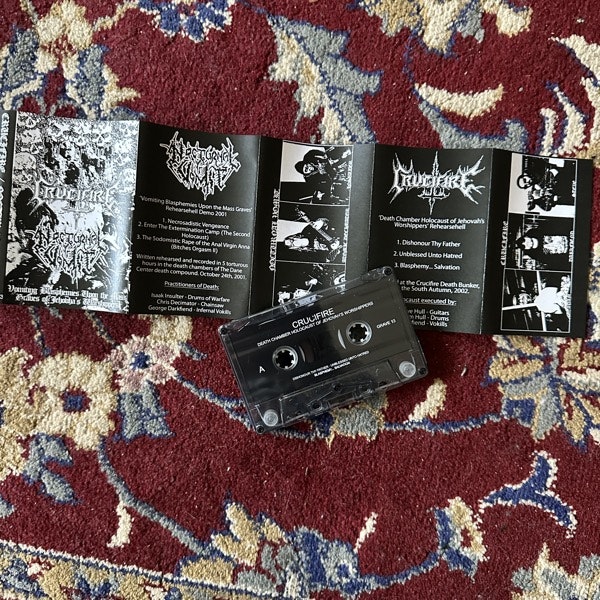 CRUCIFIRE / NOCTURNAL VOMIT Vomiting Blasphemies Upon The Mass Graves Of Jehovah's Worshippers (Grave Ritual - Spain reissue) (NM) TAPE