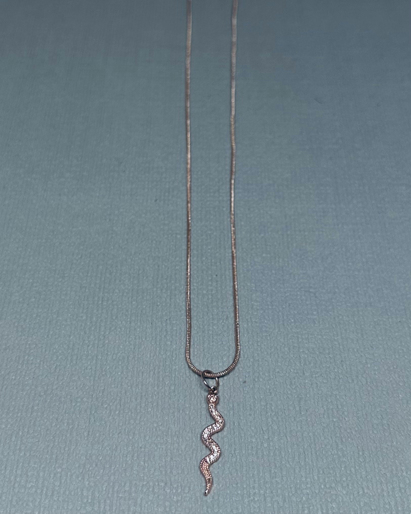Snake jewelled charm necklace
