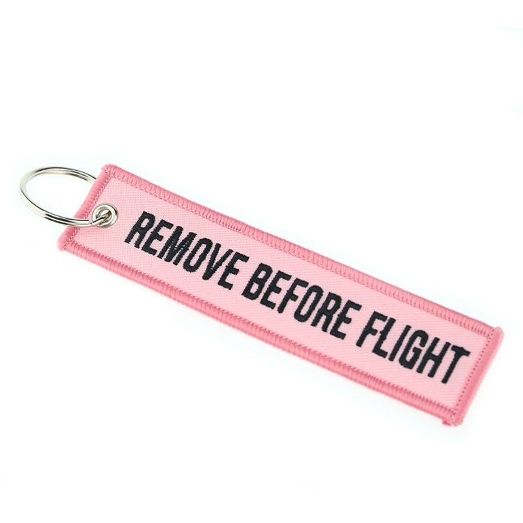 Mc-Nyckelring Remove before flight - rosa