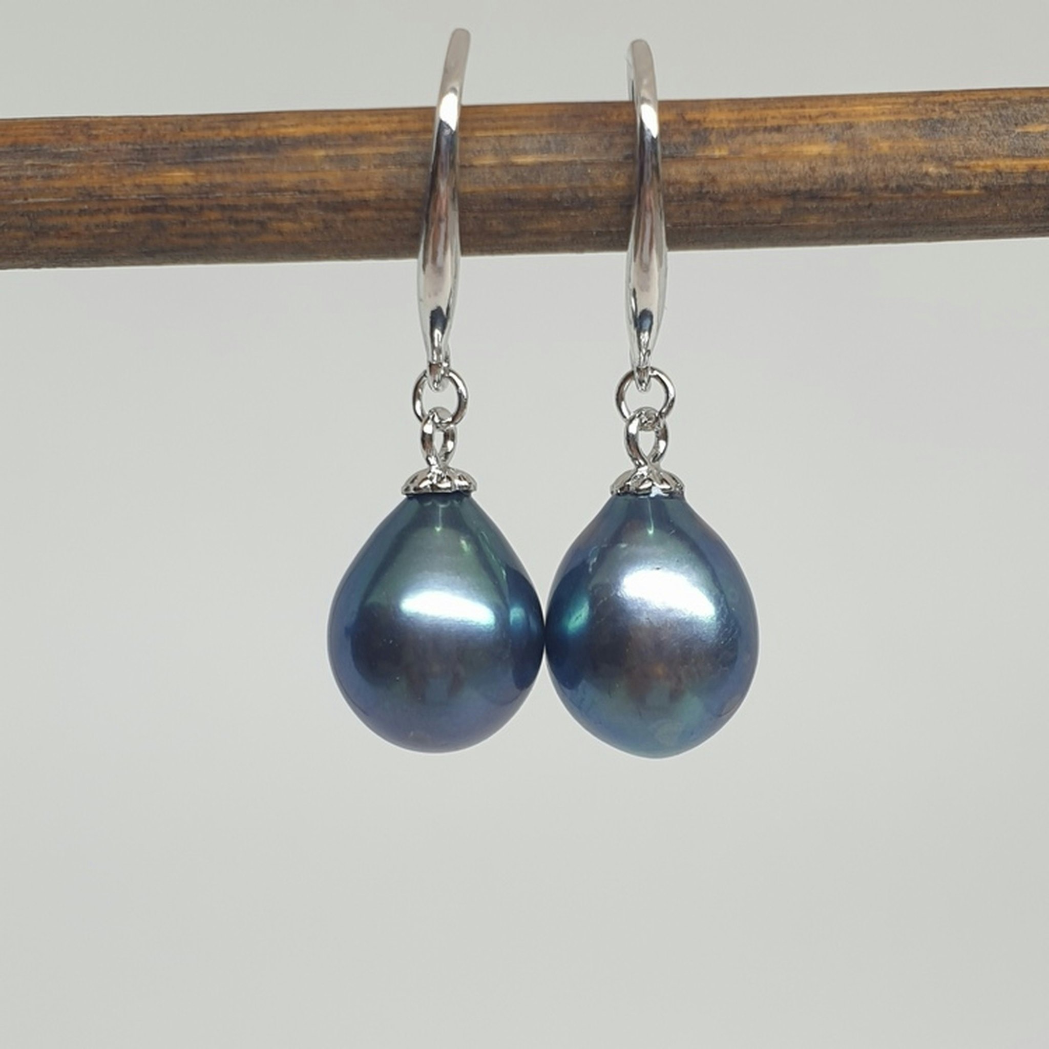Stora blå-gröna vackert droppformade pärlor på silverkrok