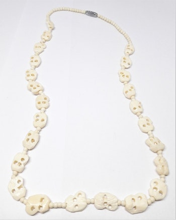 Halsband i ben med snidade figurer