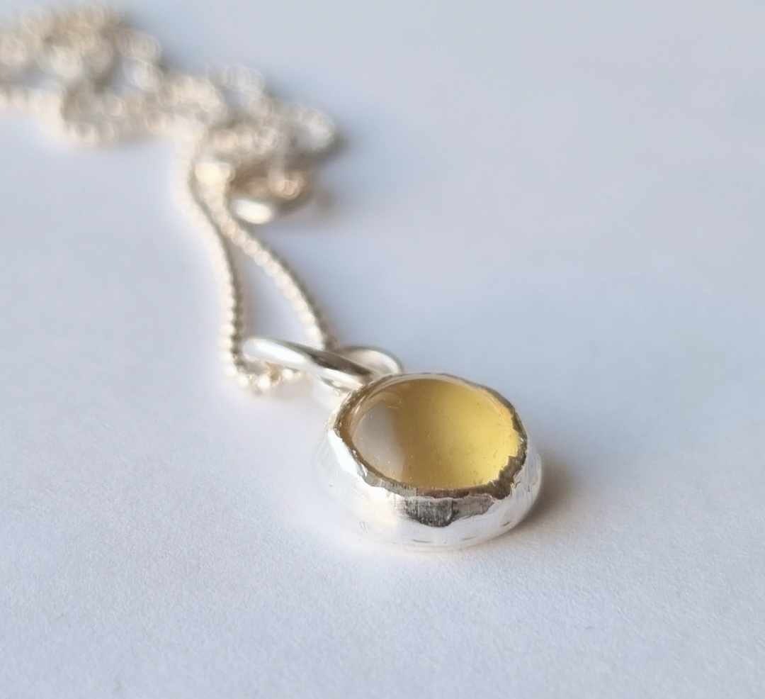 Silver necklace with set yellow stone, cabochon