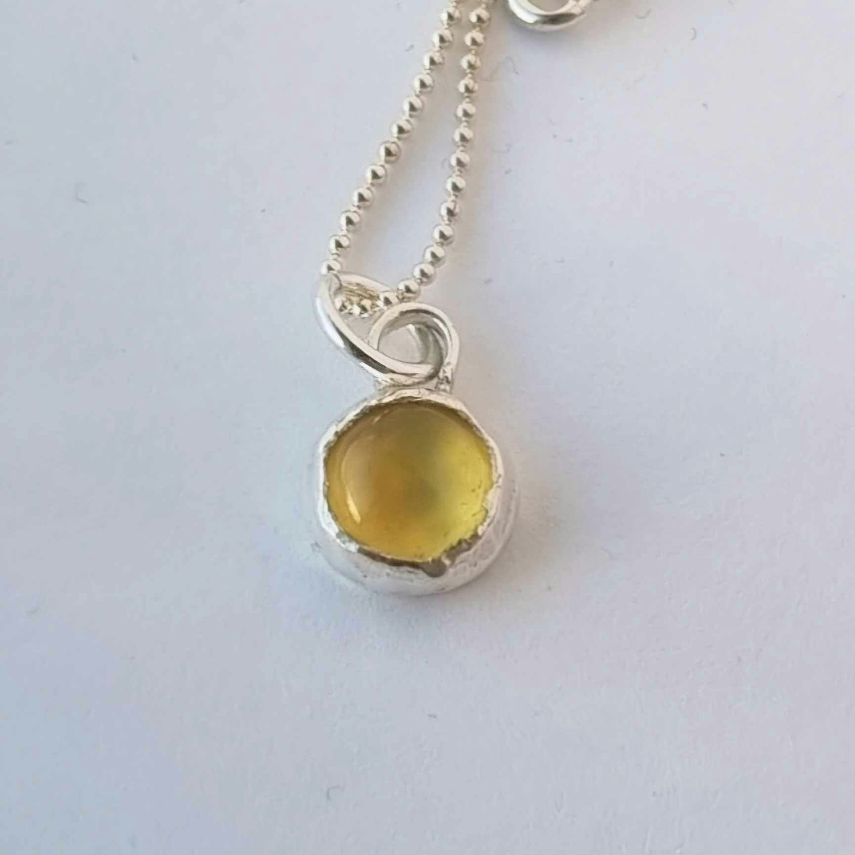 Silver necklace with set yellow stone, cabochon