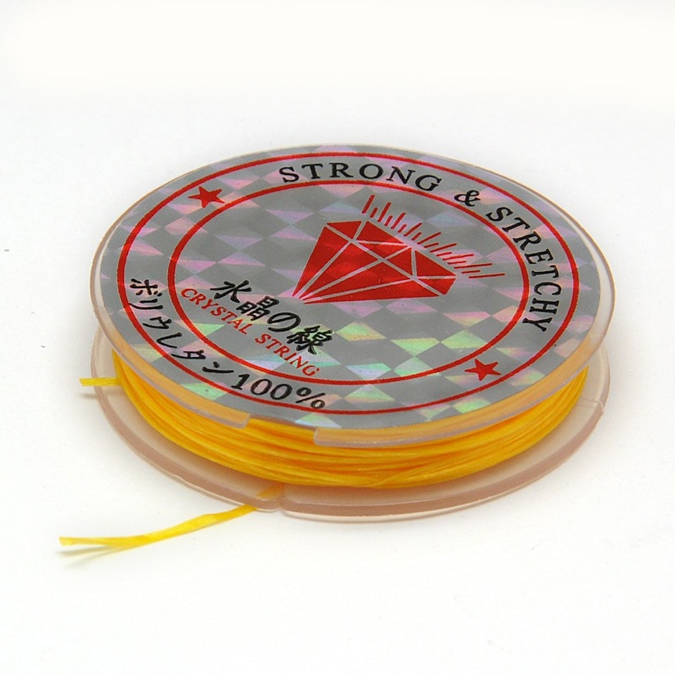Färgad Elastisk nylontråd på rulle 0,6mm Guld