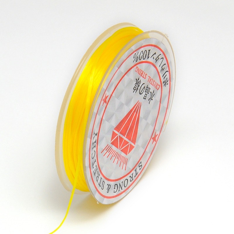 Färgad Elastisk nylontråd på rulle 0,6mm Gul