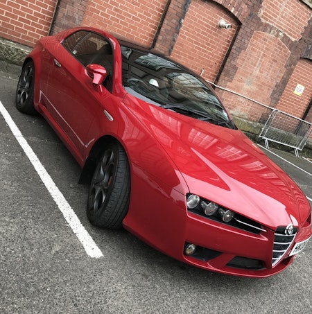 Red alfa romeo with mudflaps fitted