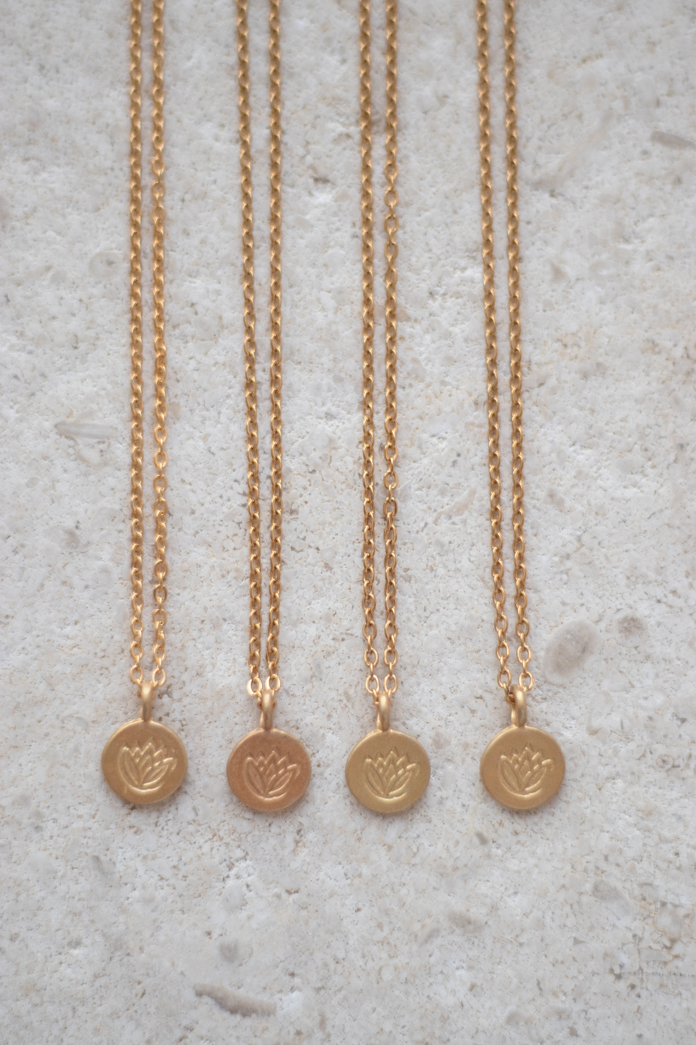 Necklace in gold with a dainty lotus pendant