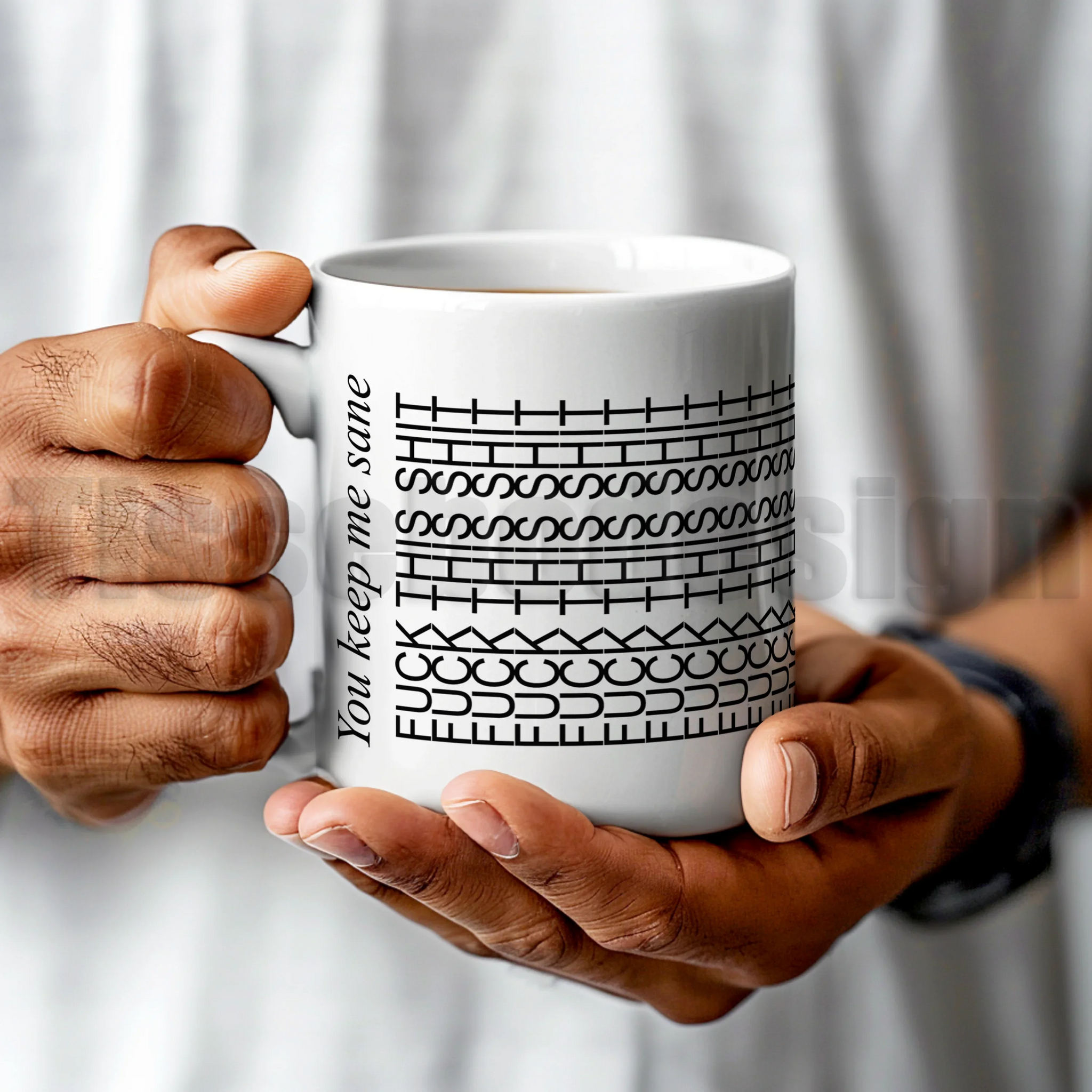 Mugg med texten FCK THIS SHIT i upprepat grafiskt mönster och orden You keep me sane på sidan – keramikmugg 330 ml.