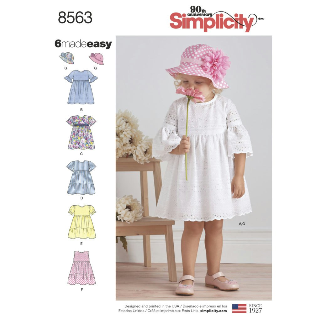 Simplicity8563 Kjole med rynker, puffermer og volanger. Solhatt.