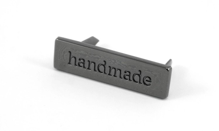 Metal bag label: "handmade", rectangle