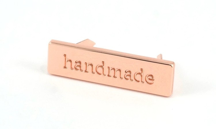 Metal bag label: "handmade", rectangle