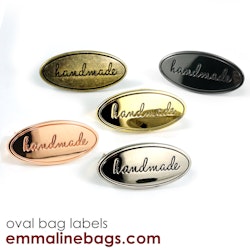 Metal bag label: "handmade", oval