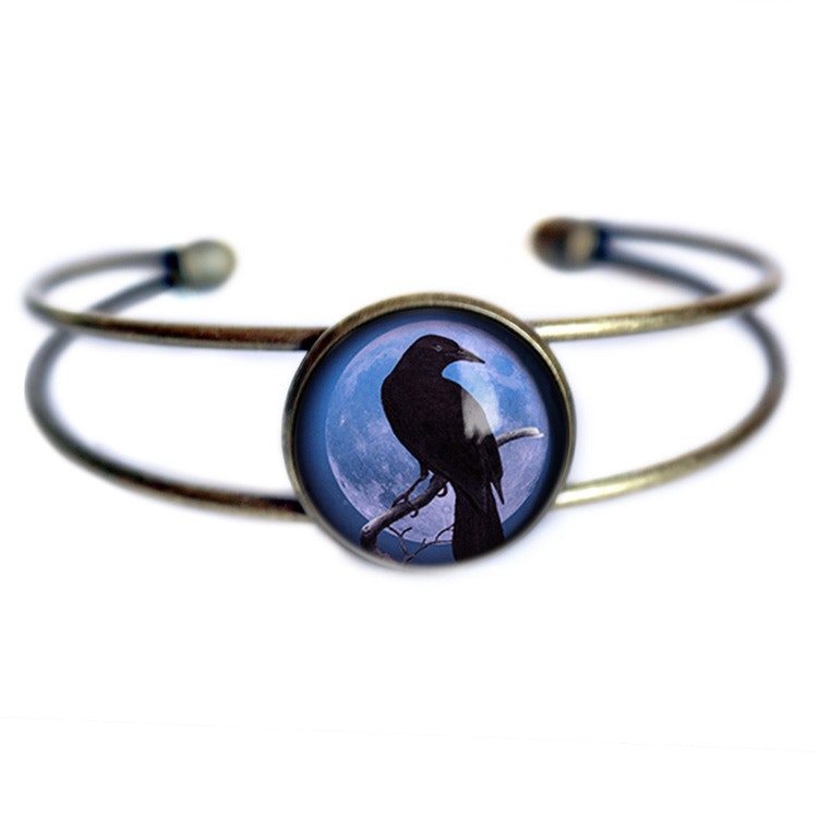 Manschettarmband – Kråkfågel, blå måne