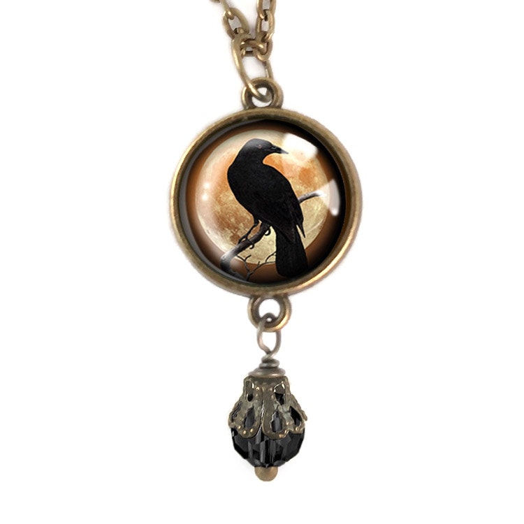 Vintageinspirerat halsband med en berlock med illustration av en kråkfågel.