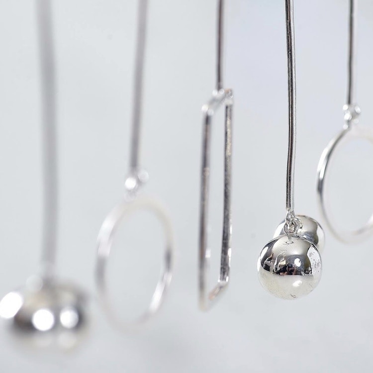 flera silverörhängen med olika former. silver earrings with various designs.