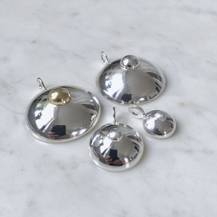 Silverhängen i form av hängbröst, i tre olika storlekar. Silver pendants in three sizes