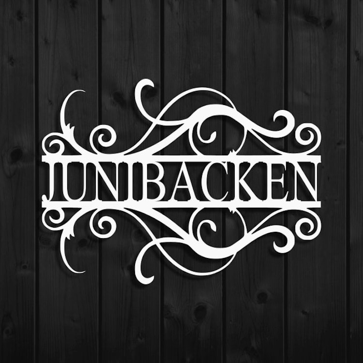 Metalldekor i snygg vågig design med texten Junibacken.
