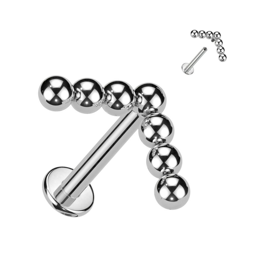 Labret / flat back piercing i titanium 1,2mm med V-formad bollkluster