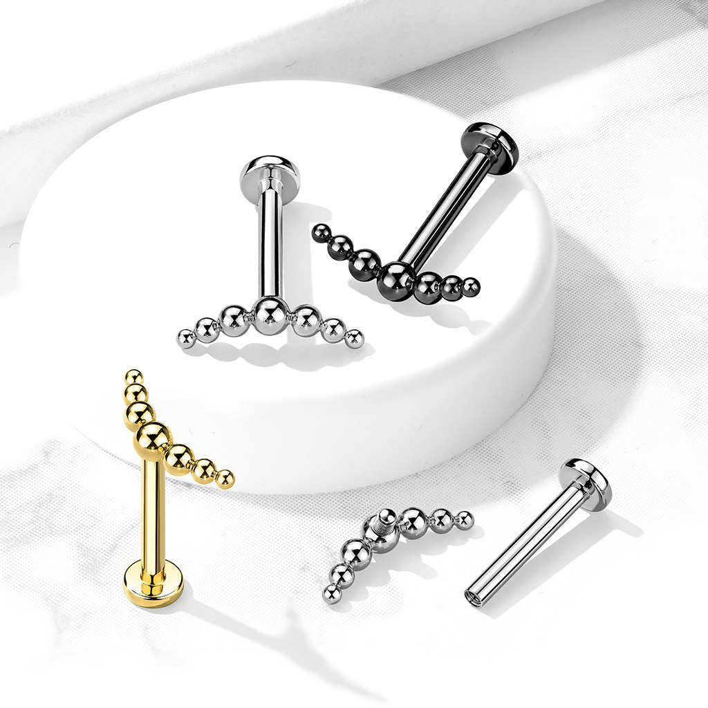 Labret / flat back piercing i titanium 1,2mm med lätt böjd topp med 7 kulor