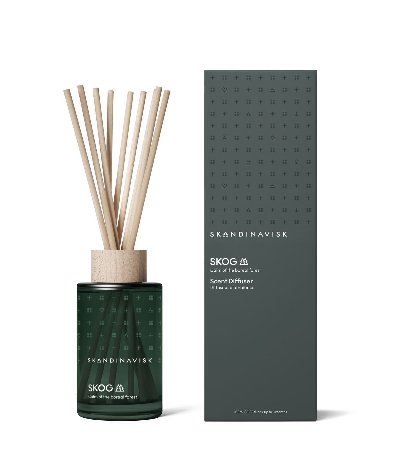 Smaller sized room diffuser from Skandinavisk with the scent of the Nordic forests, in luxury dark green glass, 8 reeds and all natural and vegan scent.