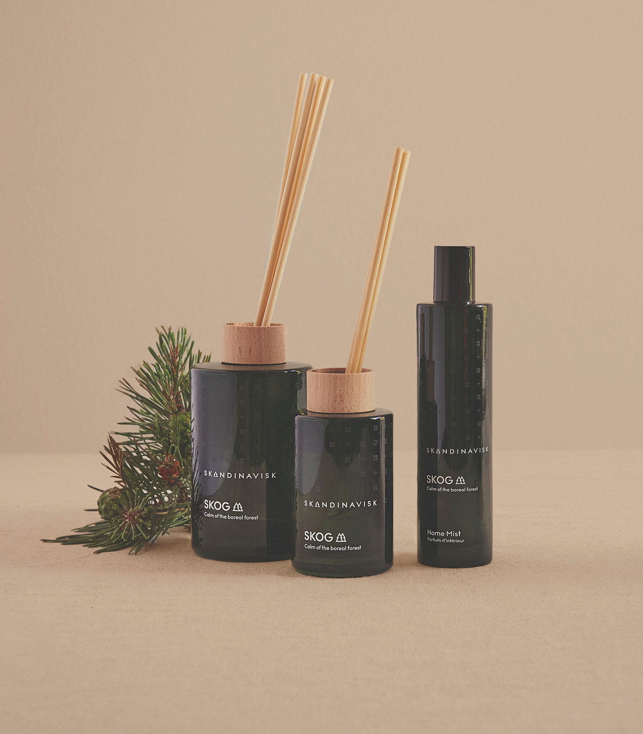 Home fragrance collection in Skog scent from Skandinavisk with the scent of the Nordic forests, in luxury dark green glass,  all natural and vegan scent.