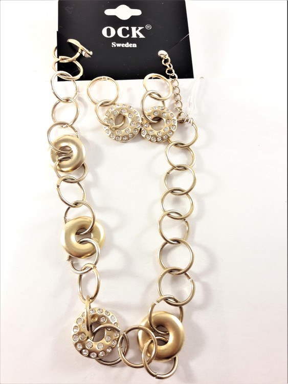 Dekorativt och vackert lyxhalsband och örhängen, guldfärgat med strass