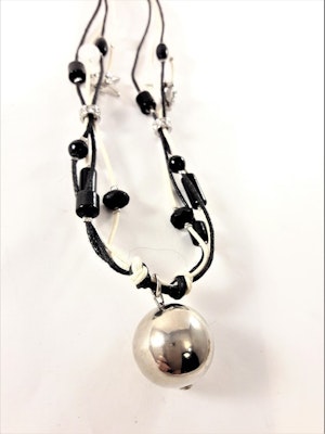 Halsband i svart och vitt med silverfärgad kula
