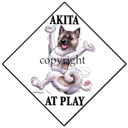Skylt "At play" – Akita