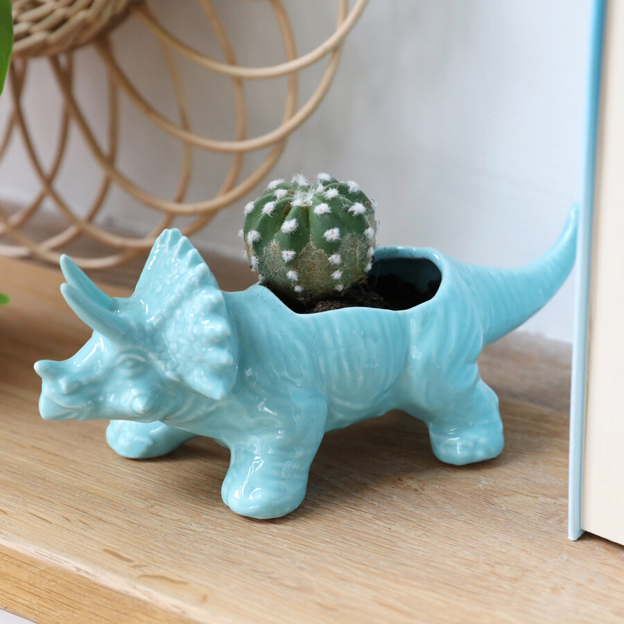 Bild på en blå kruka i keramik i form av en triceratops