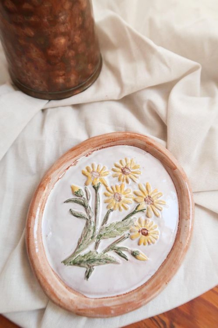 Liten keramiktavla med blommor