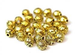 Antikt guldfärgade mönstrade små metallpärlor 6 mm, ca 50 st