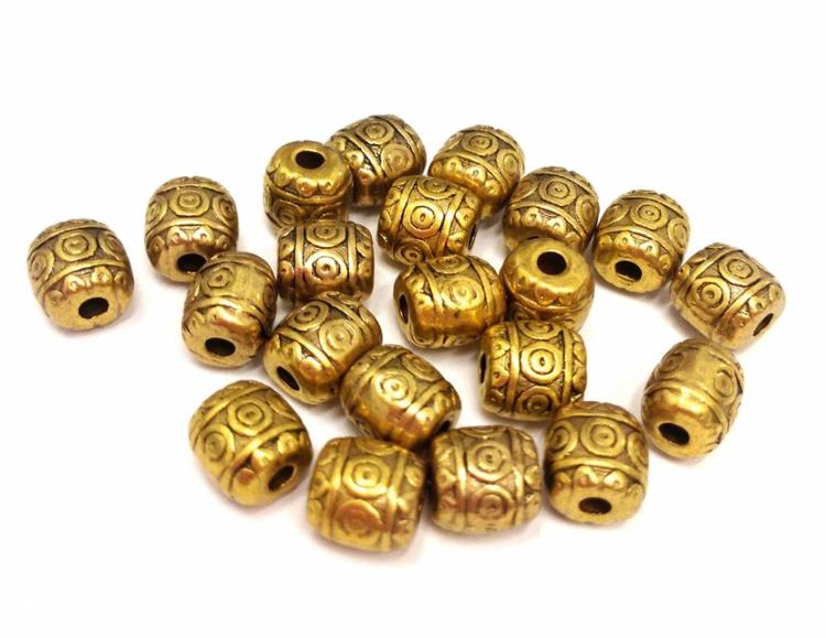 Antikt guldfärgade små mönstrade tunnor, ca 100 st