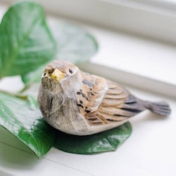 Hand-carved house sparrow chick in wood