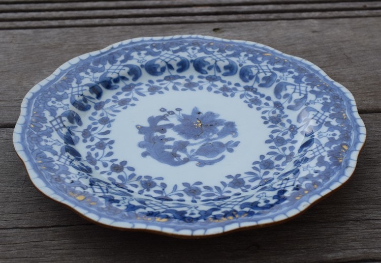 A antique chinese blue and white dish with molded rim period of Qianlong