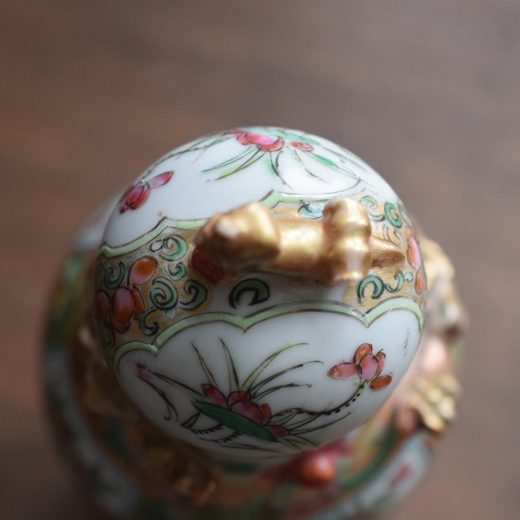 An antique canton rose lidded vase with gold gilded dragon decoration