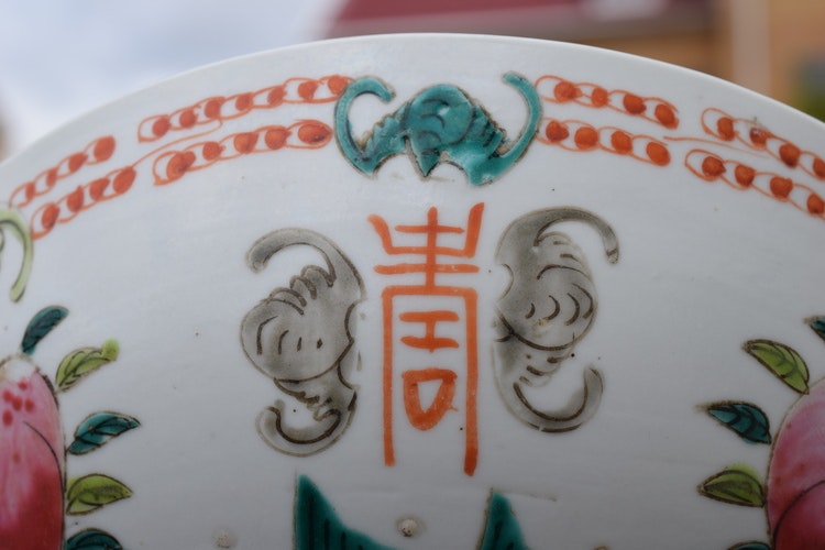 A large antique chinese bowl decorated with peach & bats Late Qing Dynasty